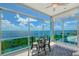 Sunroom with glass walls, water views, and seating area for relaxing at 5444 Gulf Of Mexico Dr, Longboat Key, FL 34228