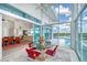 Indoor dining space with glass walls and pool access at 5444 Gulf Of Mexico Dr, Longboat Key, FL 34228