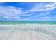 Calm ocean waves lapping on pristine white sand beach at 5444 Gulf Of Mexico Dr, Longboat Key, FL 34228