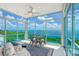Bright sunroom with water views and seating area at 5444 Gulf Of Mexico Dr, Longboat Key, FL 34228