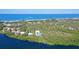 Aerial view of a waterfront property with a home and private dock at 5444 Gulf Of Mexico Dr, Longboat Key, FL 34228