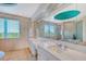 Spa-like bathroom with a double vanity and a large soaking tub at 5444 Gulf Of Mexico Dr, Longboat Key, FL 34228
