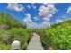 Nature path leads to waterfront views at 5444 Gulf Of Mexico Dr, Longboat Key, FL 34228