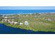 Aerial view of waterfront property with lush landscaping and ocean access at 5444 Gulf Of Mexico Dr, Longboat Key, FL 34228
