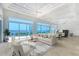 Spacious living room with water views, multiple seating areas, and an open floor plan at 5444 Gulf Of Mexico Dr, Longboat Key, FL 34228