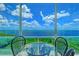 Balcony with table and chairs overlooking the water at 5444 Gulf Of Mexico Dr, Longboat Key, FL 34228