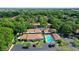 Aerial view of a community with numerous buildings, lush landscaping, and a pool at 773 N Jefferson Ave # 773, Sarasota, FL 34237