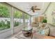 Spacious sunroom with large windows, a ceiling fan, and comfortable furniture at 773 N Jefferson Ave # 773, Sarasota, FL 34237