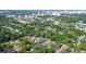 An aerial shot showing a community of houses and a pool, surrounded by trees and green space at 773 N Jefferson Ave # 773, Sarasota, FL 34237