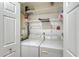 Practical laundry room with washer, dryer, and storage shelves at 773 N Jefferson Ave # 773, Sarasota, FL 34237