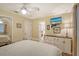 Bright bedroom with a queen bed, ceiling fan, and access to en-suite bathroom at 773 N Jefferson Ave # 773, Sarasota, FL 34237