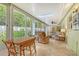 Bright sunroom with ample seating, ceiling fan, and views of the backyard at 773 N Jefferson Ave # 773, Sarasota, FL 34237
