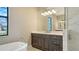 Bathroom vanity featuring a white countertop, dark wood cabinets, and a soaking tub at 10629 Nicklaus Ct, Englewood, FL 34223