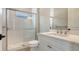 Modern bathroom with shower, glass door, brushed-nickel fixtures, and stylish vanity at 10629 Nicklaus Ct, Englewood, FL 34223