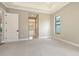 Bedroom featuring tray ceilings, neutral tones, and carpeted floor at 10629 Nicklaus Ct, Englewood, FL 34223