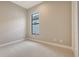 Empty bedroom with carpeted floor and base molding at 10629 Nicklaus Ct, Englewood, FL 34223