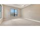 Neutral bedroom with a large window overlooking the pool area at 10629 Nicklaus Ct, Englewood, FL 34223