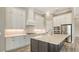 Gourmet kitchen featuring a large island, white cabinets, and stainless steel appliances at 10629 Nicklaus Ct, Englewood, FL 34223