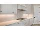 Detailed shot of the kitchen with white cabinets and under cabinet lighting at 10629 Nicklaus Ct, Englewood, FL 34223