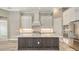 Gourmet kitchen featuring a large island, white cabinets, and stainless steel appliances at 10629 Nicklaus Ct, Englewood, FL 34223