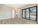 Light-filled living room boasts wood-look tile, white trim, and doors to the patio at 10629 Nicklaus Ct, Englewood, FL 34223