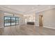 Open floor plan featuring wood-style flooring, recessed lighting, and a modern kitchen with a large island at 10629 Nicklaus Ct, Englewood, FL 34223
