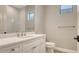 The powder room featuring a sink and toilet at 10629 Nicklaus Ct, Englewood, FL 34223