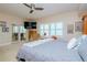 Spacious main bedroom with a king bed, ceiling fan, and balcony access at 2825 Terra Ceia Bay Blvd # 1602, Palmetto, FL 34221