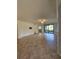 Large living room with tile floors and sliding glass doors at 5830 Wake Forest Run # 104, Bradenton, FL 34211