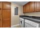 Laundry room with washer, dryer, and wood cabinets at 2825 Terra Ceia Bay Blvd # 1602, Palmetto, FL 34221