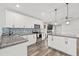 Modern kitchen with white cabinets, granite counters, and tile backsplash at 109 Henry Ave, Plant City, FL 33563