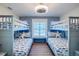 bedroom with twin bunk beds, fish bedding, and coastal decor at 2102 Avenue B, Bradenton Beach, FL 34217