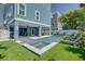 Expansive pool and spa with artificial turf and lounge chairs at 2102 Avenue B, Bradenton Beach, FL 34217