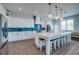 Modern kitchen with white cabinets, large island, and blue tile backsplash at 2102 Avenue B, Bradenton Beach, FL 34217