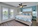 Primary bedroom with king bed, blue accents, and private balcony access at 2102 Avenue B, Bradenton Beach, FL 34217