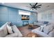 Living room with gray sofas, wood coffee tables, and a blue accent wall at 2102 Avenue B, Bradenton Beach, FL 34217