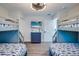 Bedroom with twin bunk beds, coastal decor, and mounted TV at 2102 Avenue B, Bradenton Beach, FL 34217