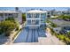 Two-story house with light blue exterior, driveway, and partial ocean view at 2102 Avenue B, Bradenton Beach, FL 34217
