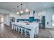 Modern kitchen with white cabinets, large island, and blue tile backsplash at 2102 Avenue B, Bradenton Beach, FL 34217