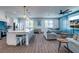 Modern kitchen with white cabinets, large island, and blue tile backsplash at 2102 Avenue B, Bradenton Beach, FL 34217