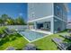 Private pool with lounge chairs, outdoor dining area, and artificial turf at 2102 Avenue B, Bradenton Beach, FL 34217