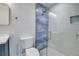 Bathroom with a glass-enclosed shower and blue tile at 2102 Avenue B, Bradenton Beach, FL 34217