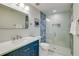 Bathroom with single vanity, blue cabinetry, and glass shower at 2102 Avenue B, Bradenton Beach, FL 34217