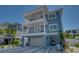 Two-story home with light blue exterior and two-car garage at 2102 Avenue B, Bradenton Beach, FL 34217