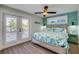 Bedroom with king-size bed, white shutters, and light wood flooring at 2102 Avenue B, Bradenton Beach, FL 34217