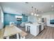 Open concept kitchen with white cabinets, stainless steel appliances, and a large island at 2102 Avenue B, Bradenton Beach, FL 34217