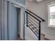 Staircase with blue accent wall and modern railing at 2102 Avenue B, Bradenton Beach, FL 34217