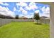 Fenced backyard with grassy lawn at 3879 Golden Oriole Pkwy, Sarasota, FL 34232