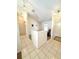 Bright foyer features tiled flooring, a half wall and ample natural light from the entry door at 623 147Th E St, Bradenton, FL 34212