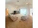 Spacious living room includes neutral carpet, ceiling fan, sliding glass door and comfortable seating at 623 147Th E St, Bradenton, FL 34212
